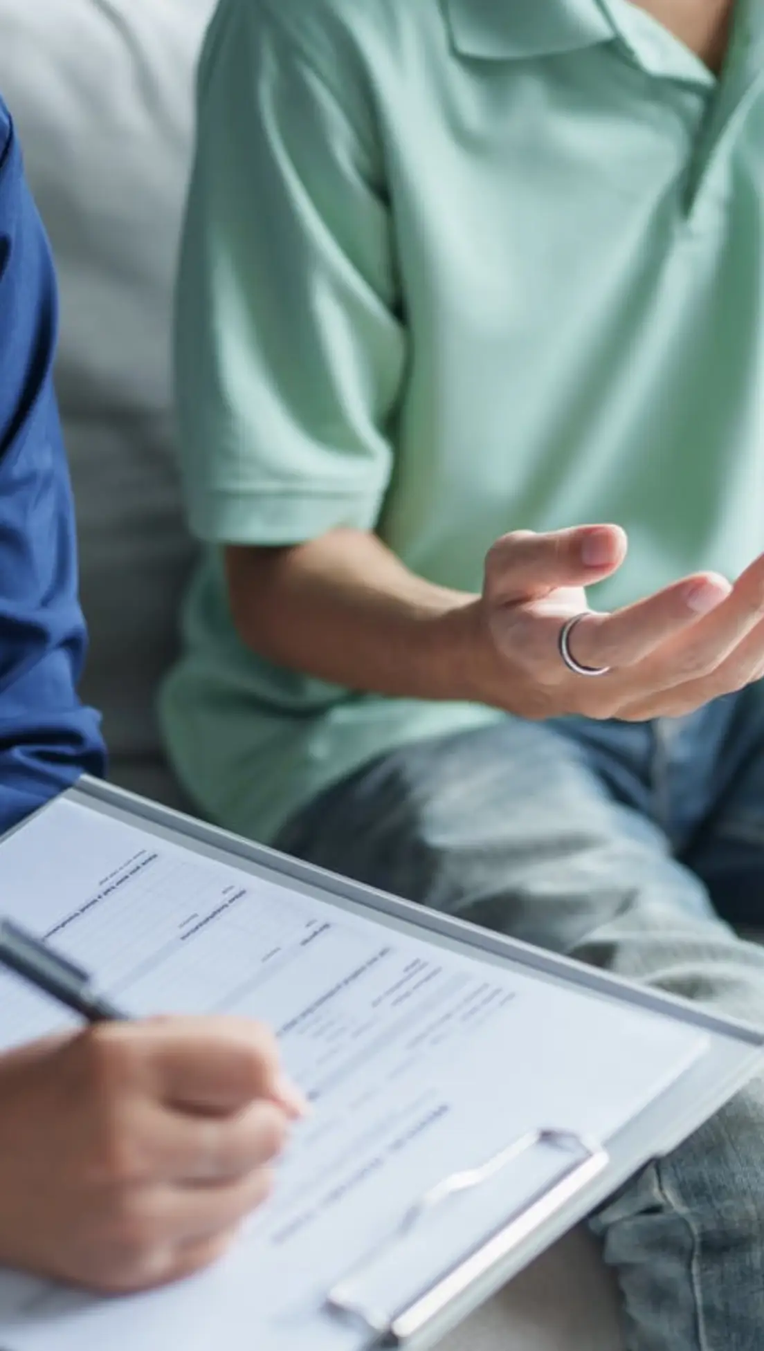 Two people discussing with paperwork.
