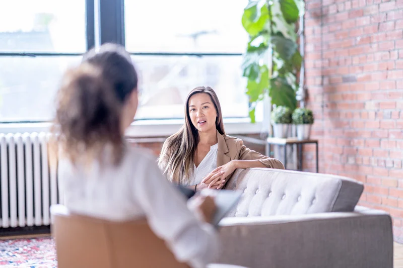 Woman talking in therapy session.
