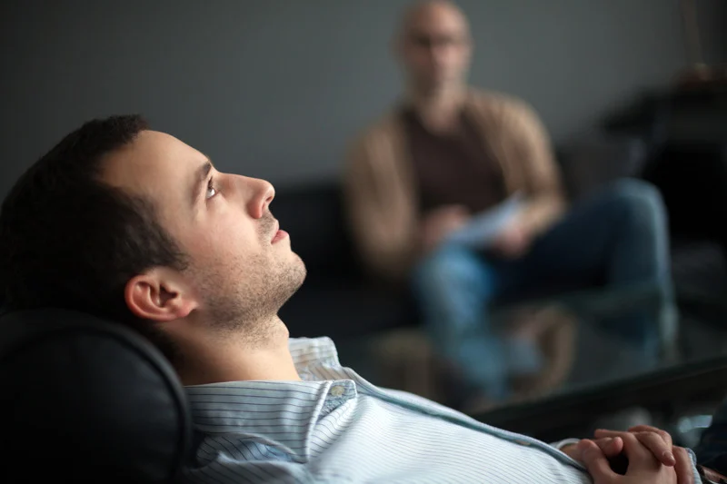 Two men in a therapy session.